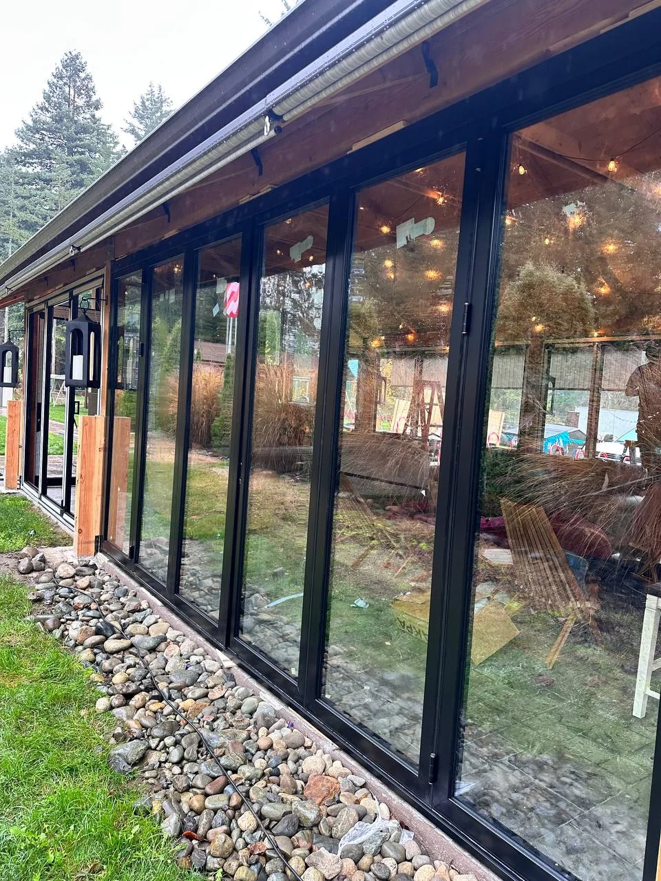 Custom residential glass enclosure with dark slim frames
